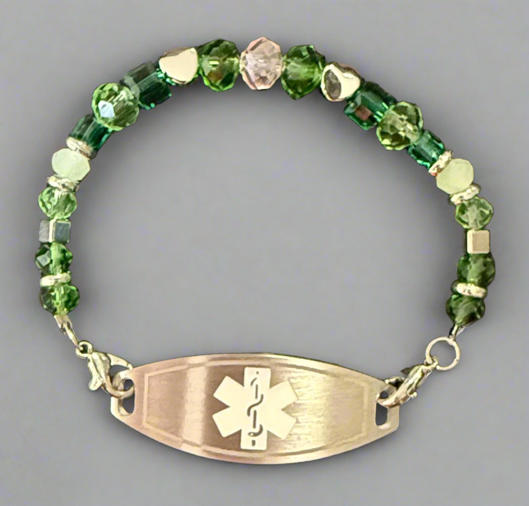 Green beaded bracelet with an emergency medical symbol on a black background