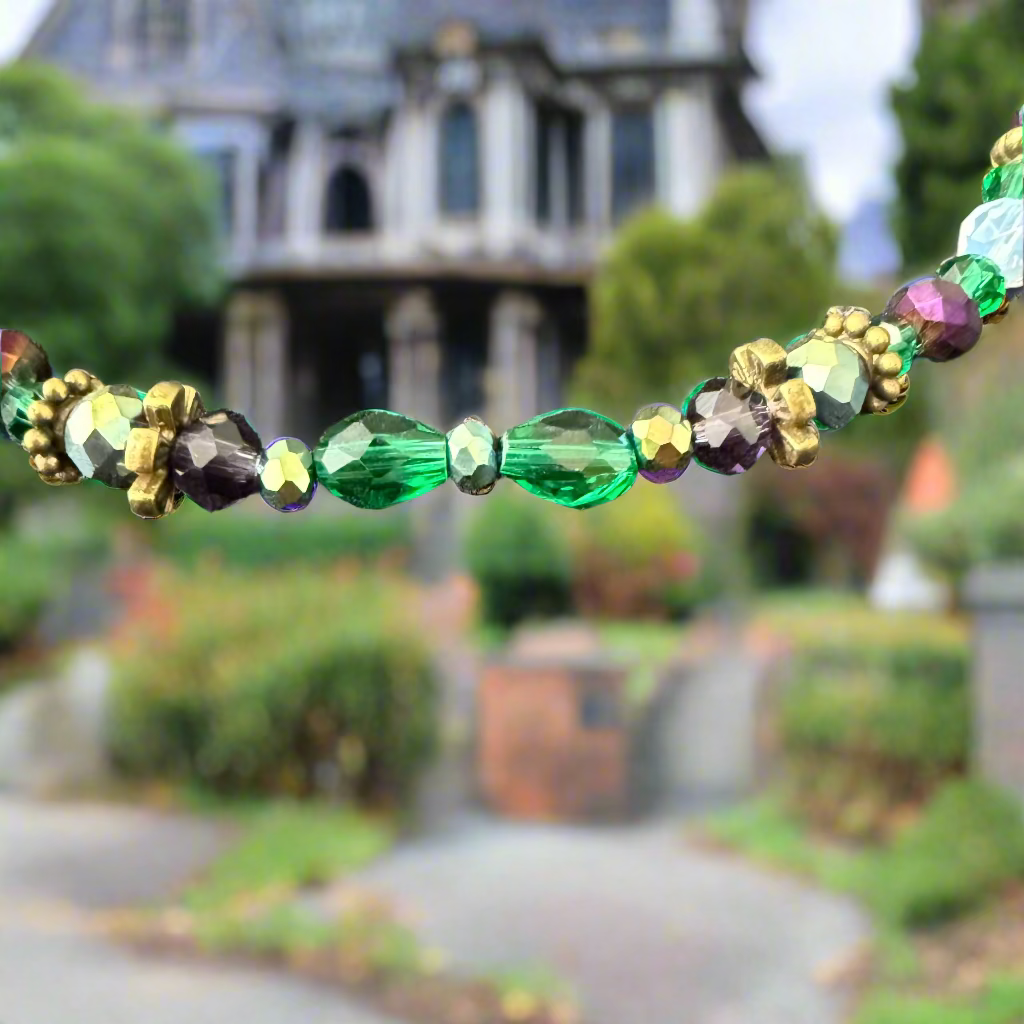 Multicolored beaded necklace on a textured gray surface