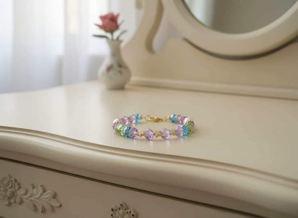 Multicolored beaded bracelet with gold accents on a black textured background