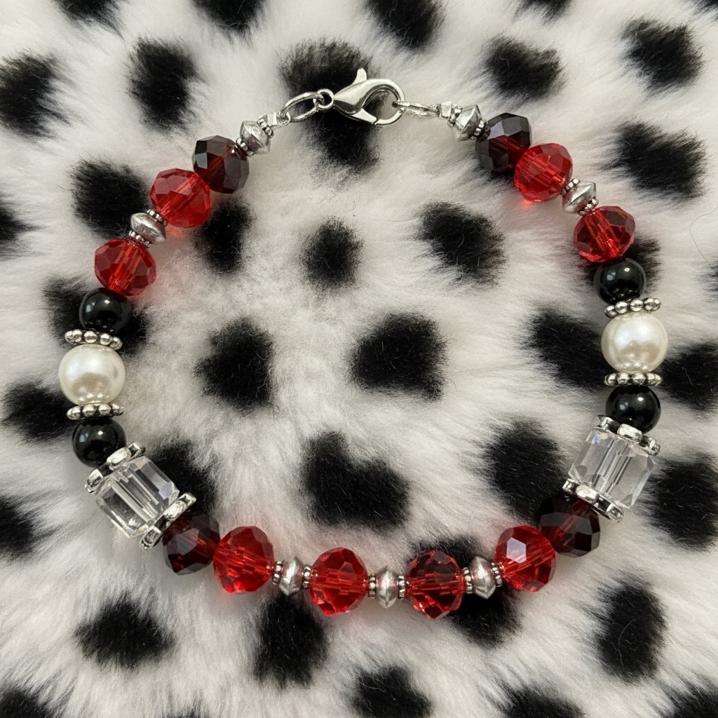 Beaded bracelet with red, black, and white beads on a dark background