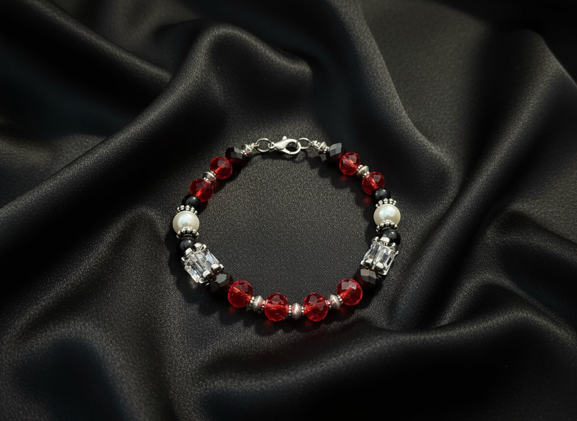 Beaded bracelet with red, black, and clear beads on a dark textured background