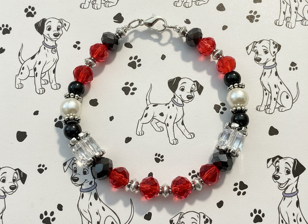 Beaded bracelet with red, black, and silver beads on a dark textured background