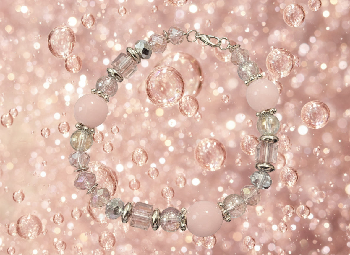 Beaded bracelet with pink and clear beads on a black background