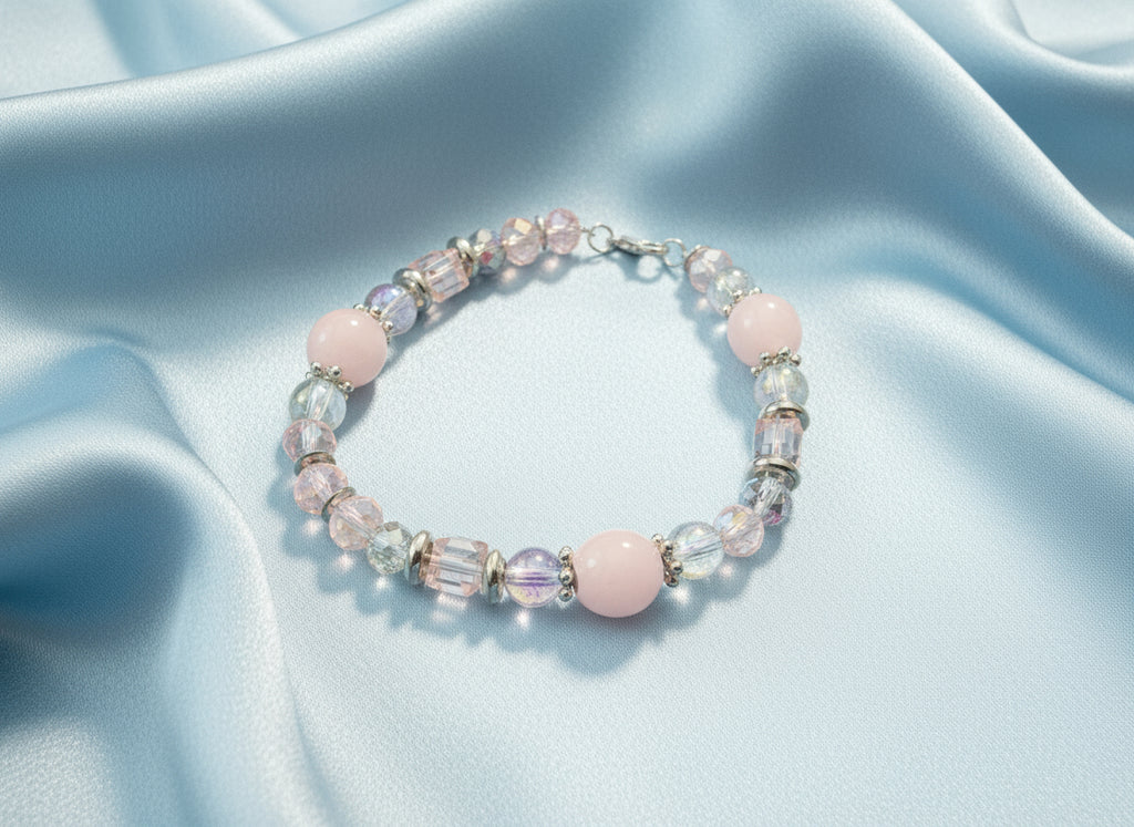 Beaded bracelet with pink and clear beads on a dark background