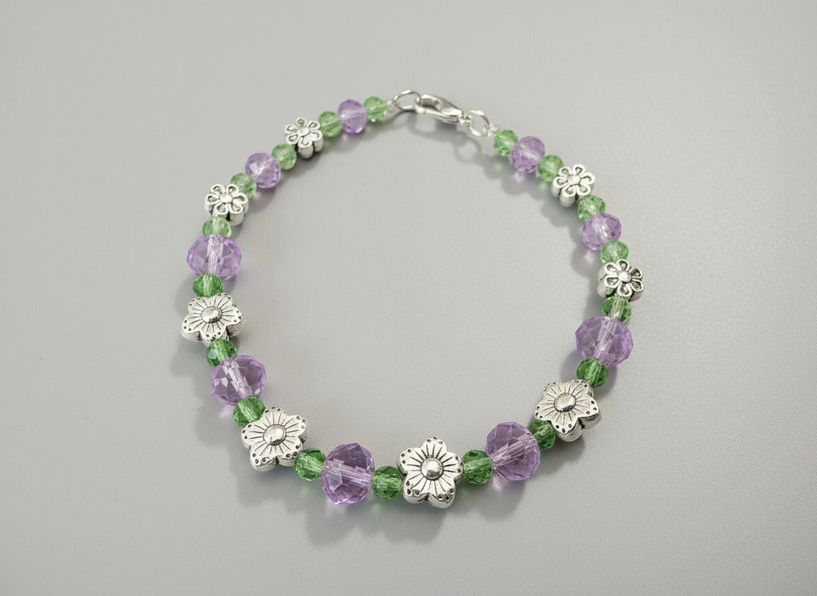 Bracelet with floral and beaded design on a black background