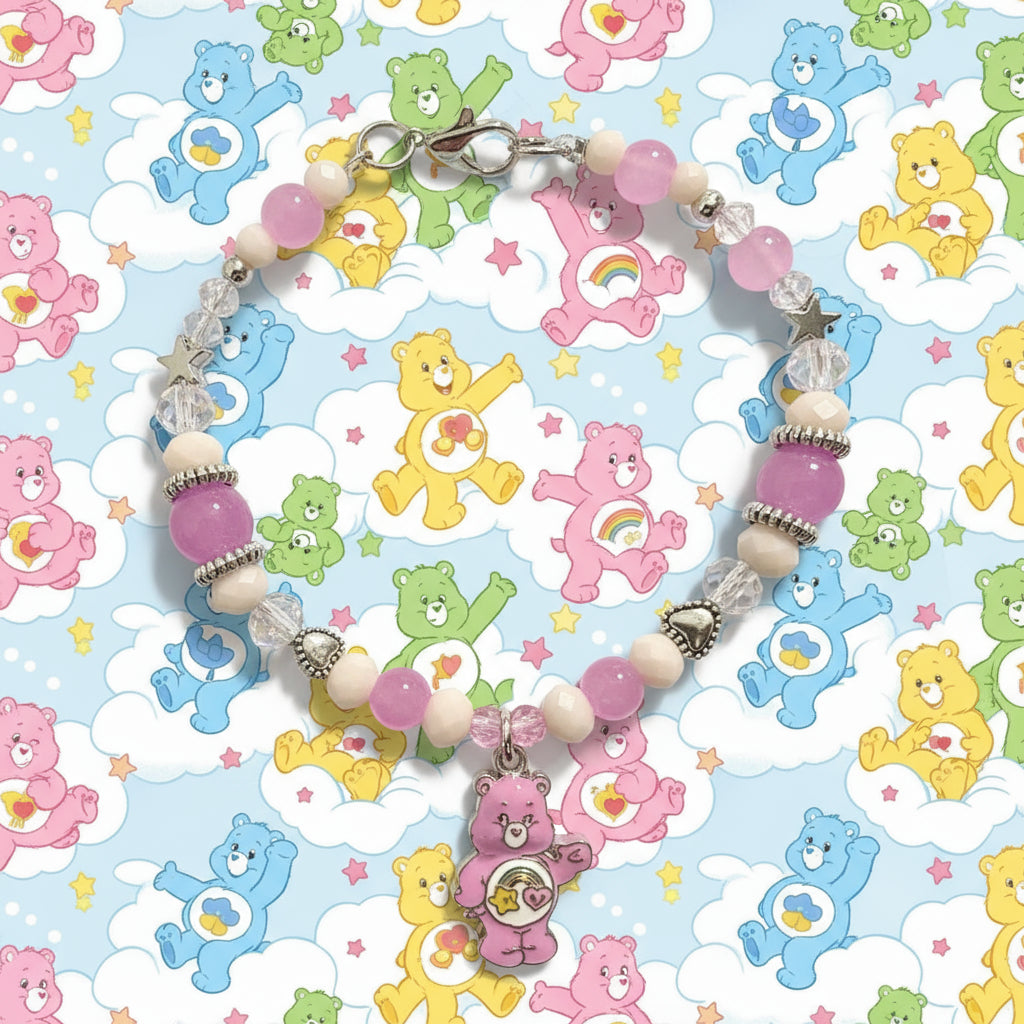 Beaded bracelet with a pink bear charm on a black background