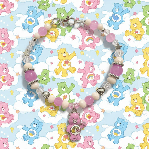 Beaded bracelet with a pink bear charm on a black background