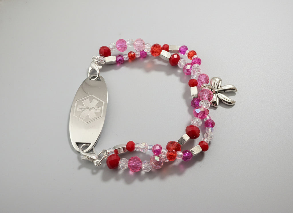 Beaded bracelet with a silver medical ID tag on a black textured background