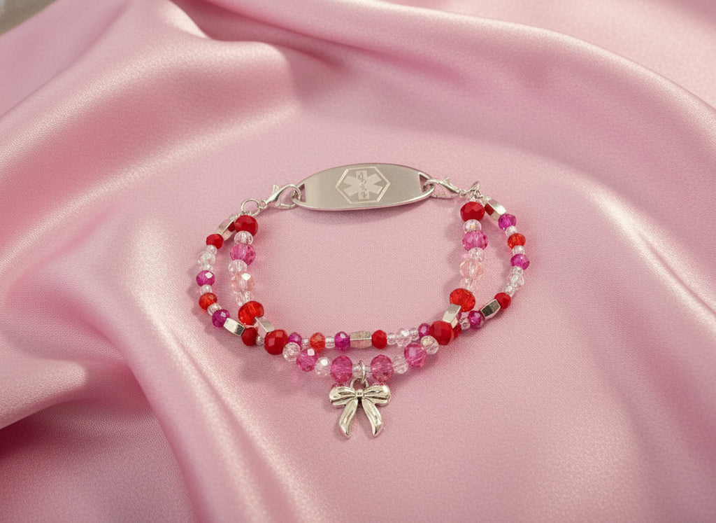 Beaded bracelet with a silver medical ID tag on a black background