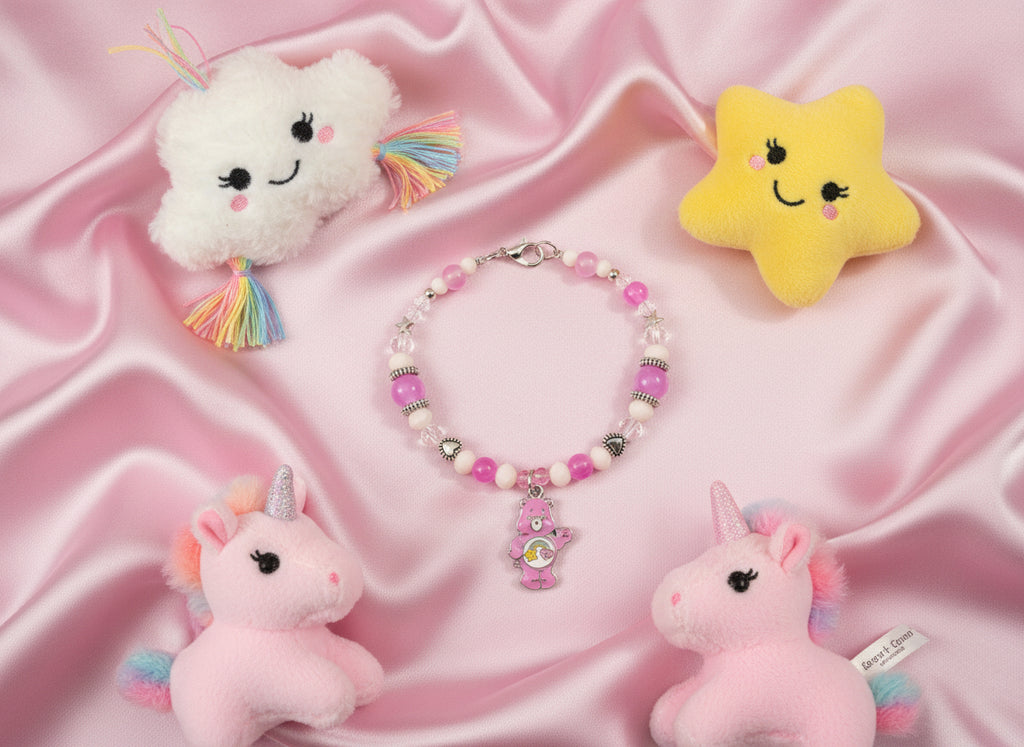 Bracelet with pink and white beads and a bear charm on a black background