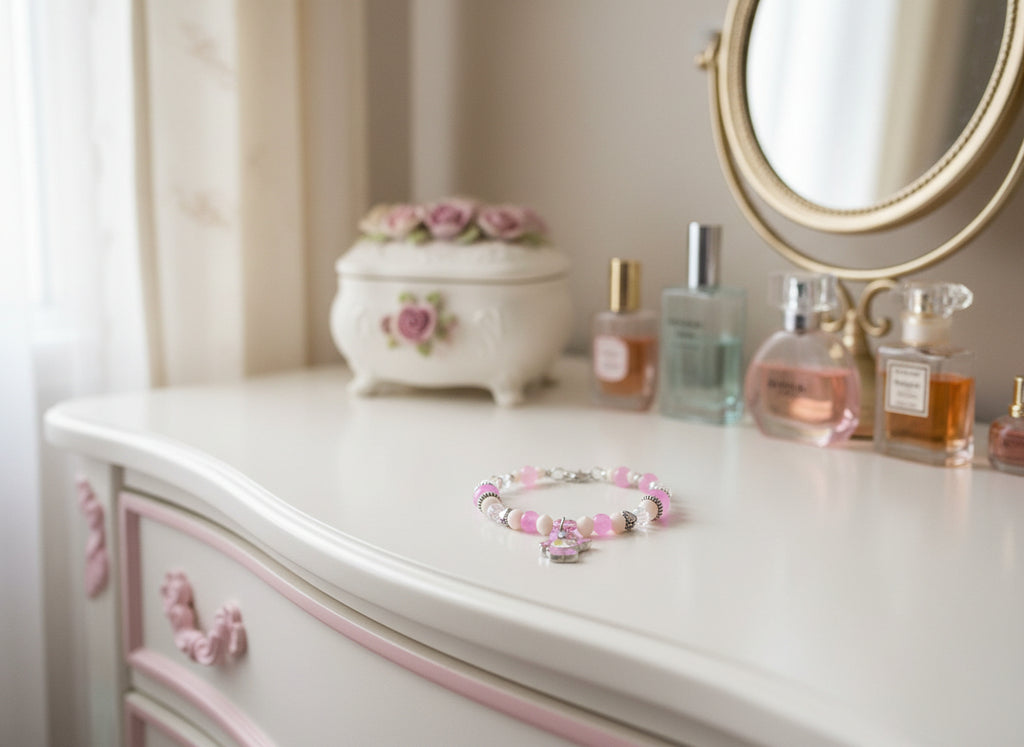Bracelet with pink and white beads and a bear charm on a black background