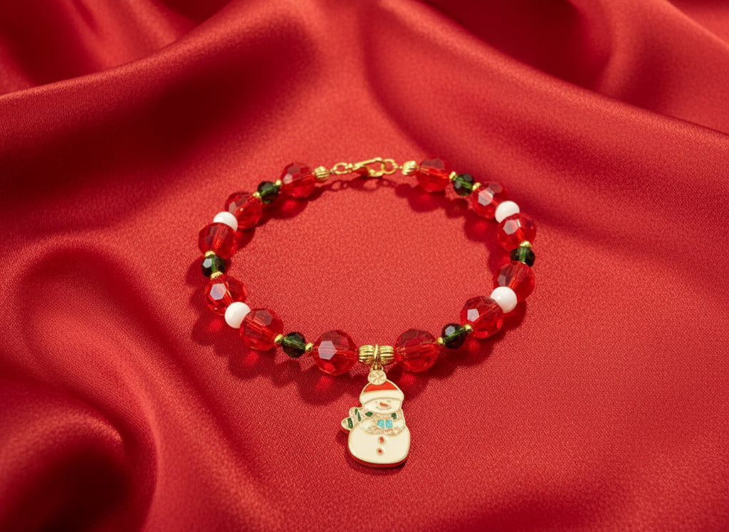 Bracelet with red beads and a snowman charm on a black background
