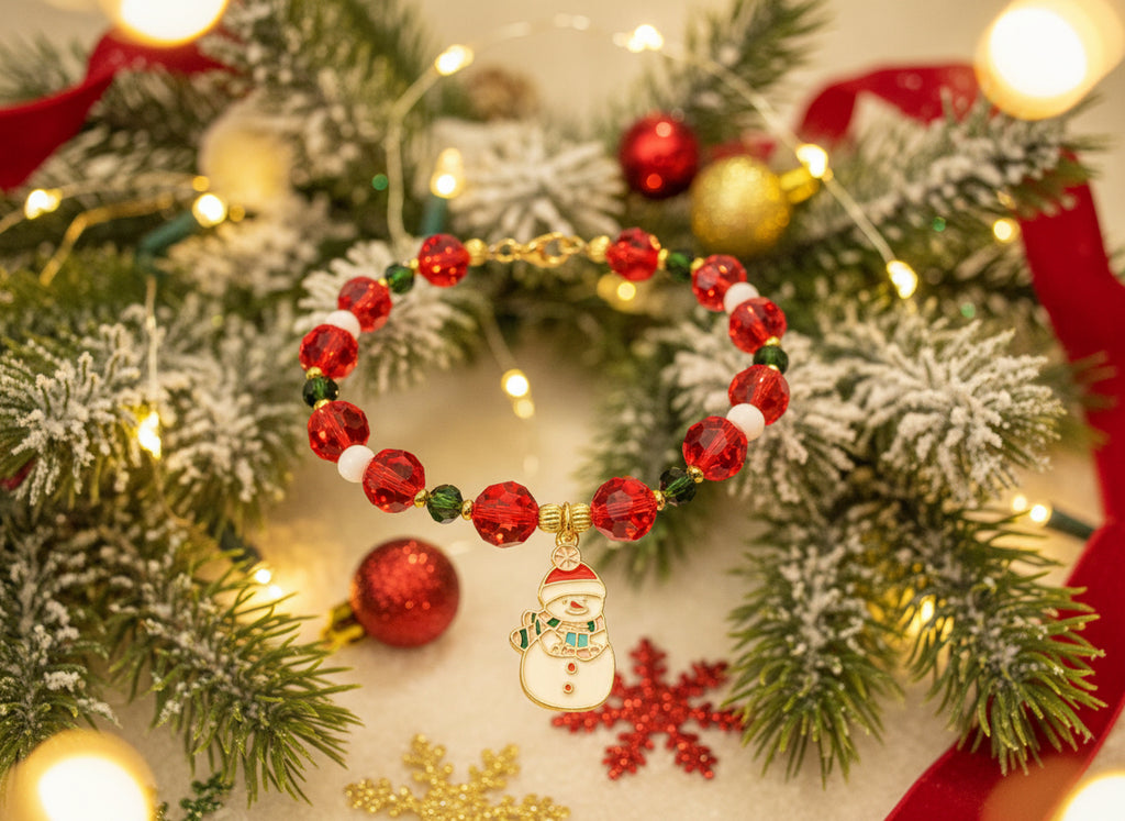 Bracelet with red beads and a snowman charm on a dark background