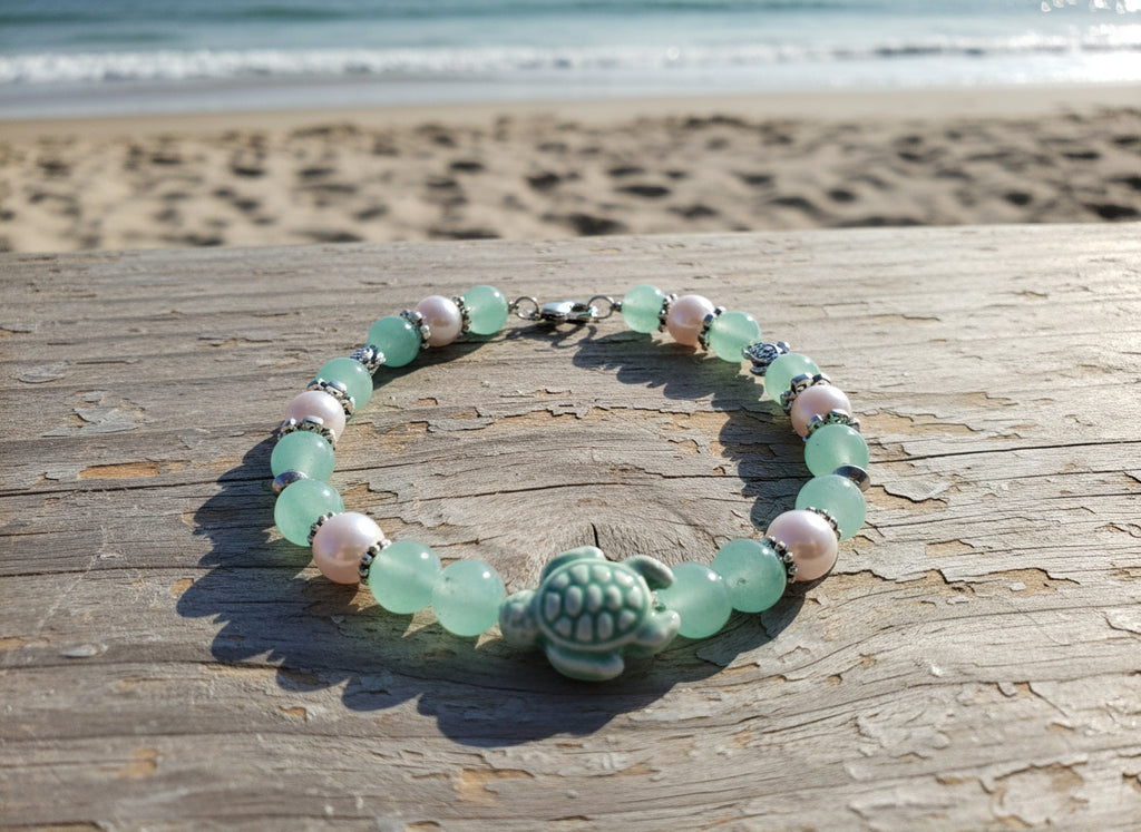 Bracelet with green and pink beads on a black background