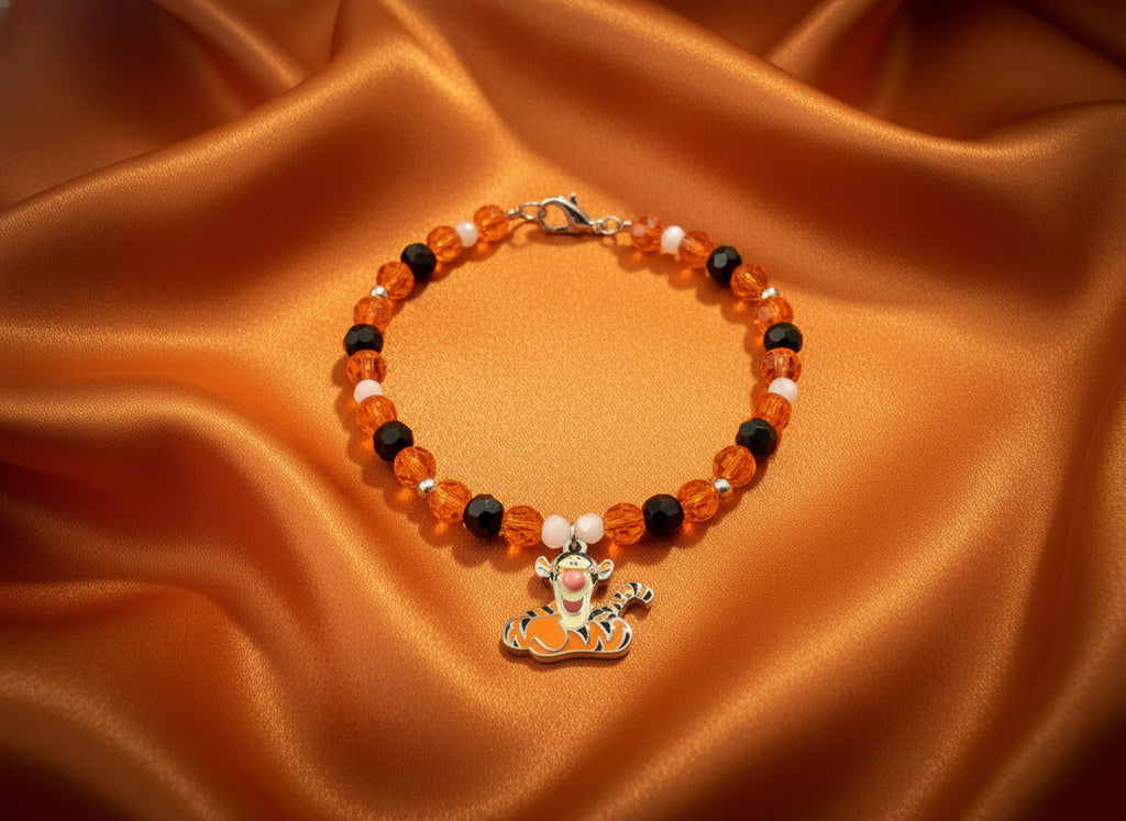 Beaded bracelet with Tigger charm on a dark textured background