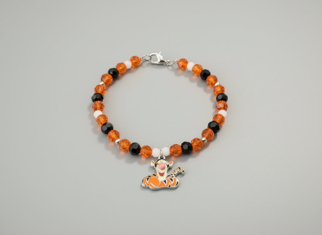 Beaded bracelet with a Tigger charm on a black background