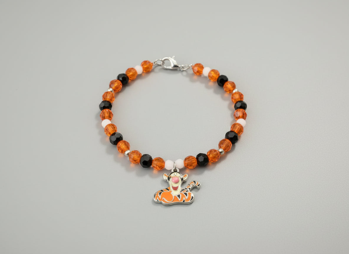 Beaded bracelet with a Tigger charm on a black background