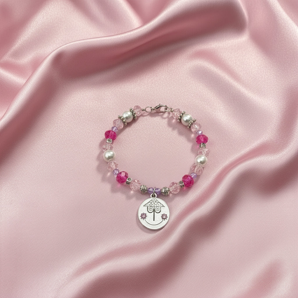 Beaded bracelet with a silver charm on a black background