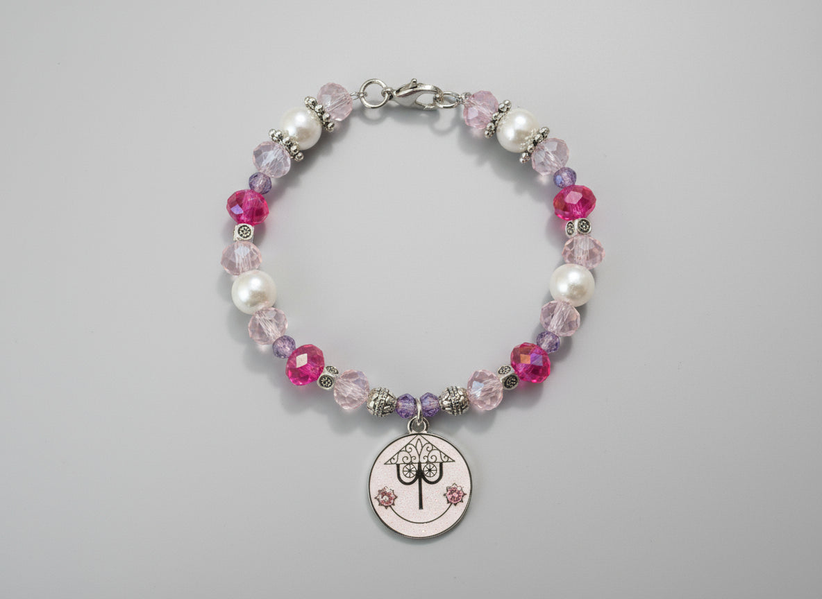 Beaded bracelet with a circular charm on a black background