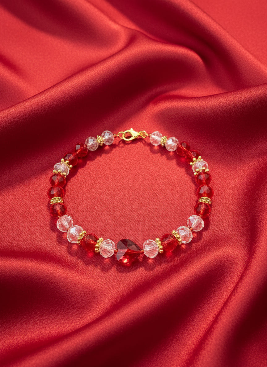 Bracelet with red and clear beads on a dark gray background