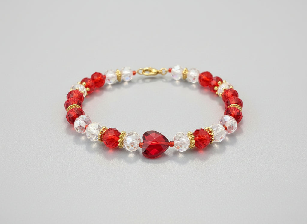 Beaded bracelet with red, clear, and gold beads on a dark textured surface