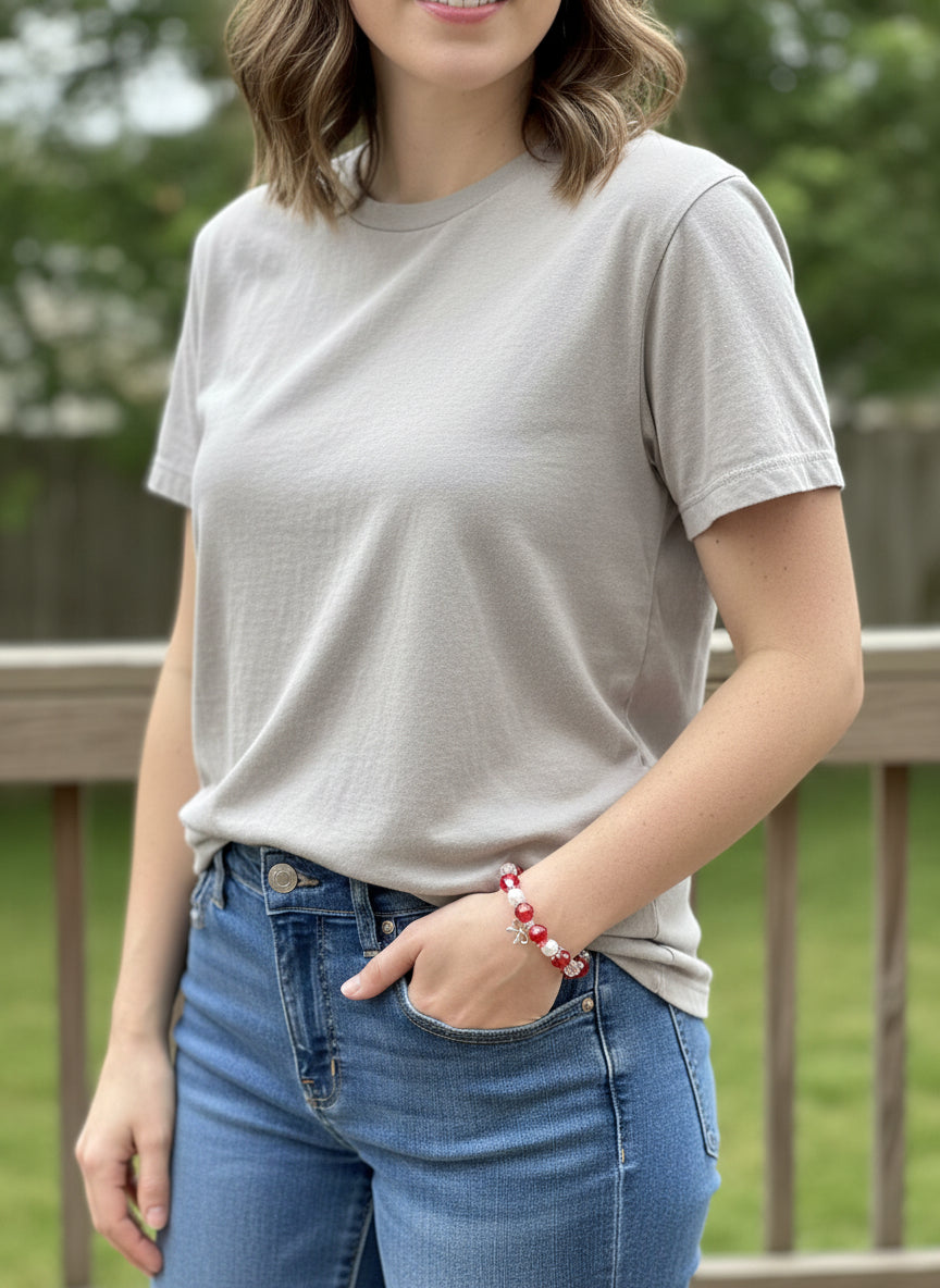 Bracelet with red, white, and clear beads on a dark background