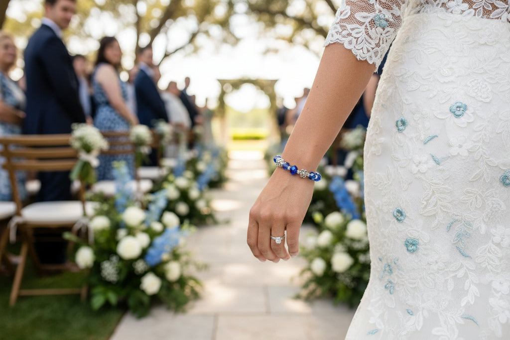 Blue beaded bracelet with silver charms on a dark background