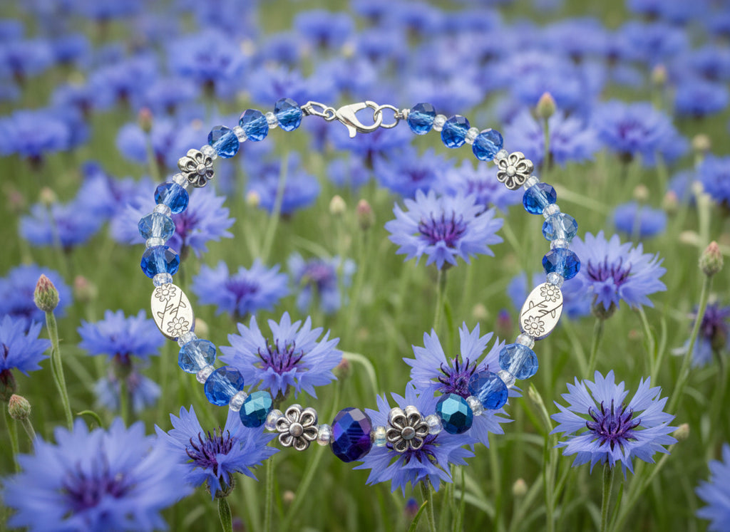 Bracelet with blue beads and floral designs on a dark textured background
