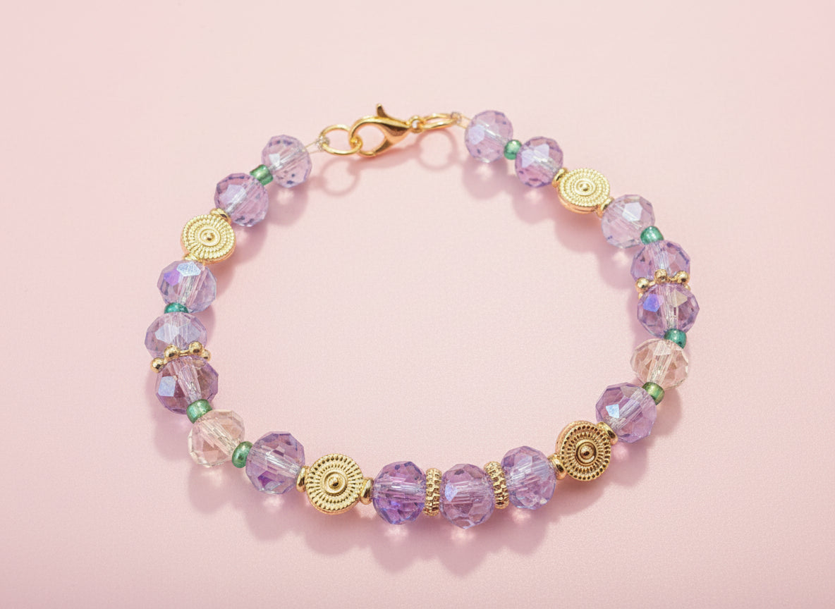 Bracelet with purple beads and gold accents on a black background