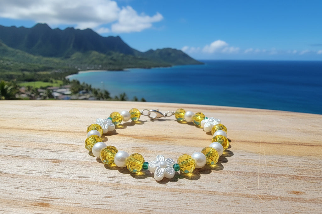 Bracelet with yellow beads, white pearls, and silver flower-shaped clasps on a dark background
