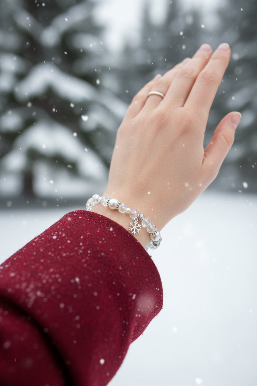 Beaded bracelet with a snowflake charm on a dark textured background