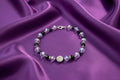 Beaded bracelet with purple and black beads on a dark background