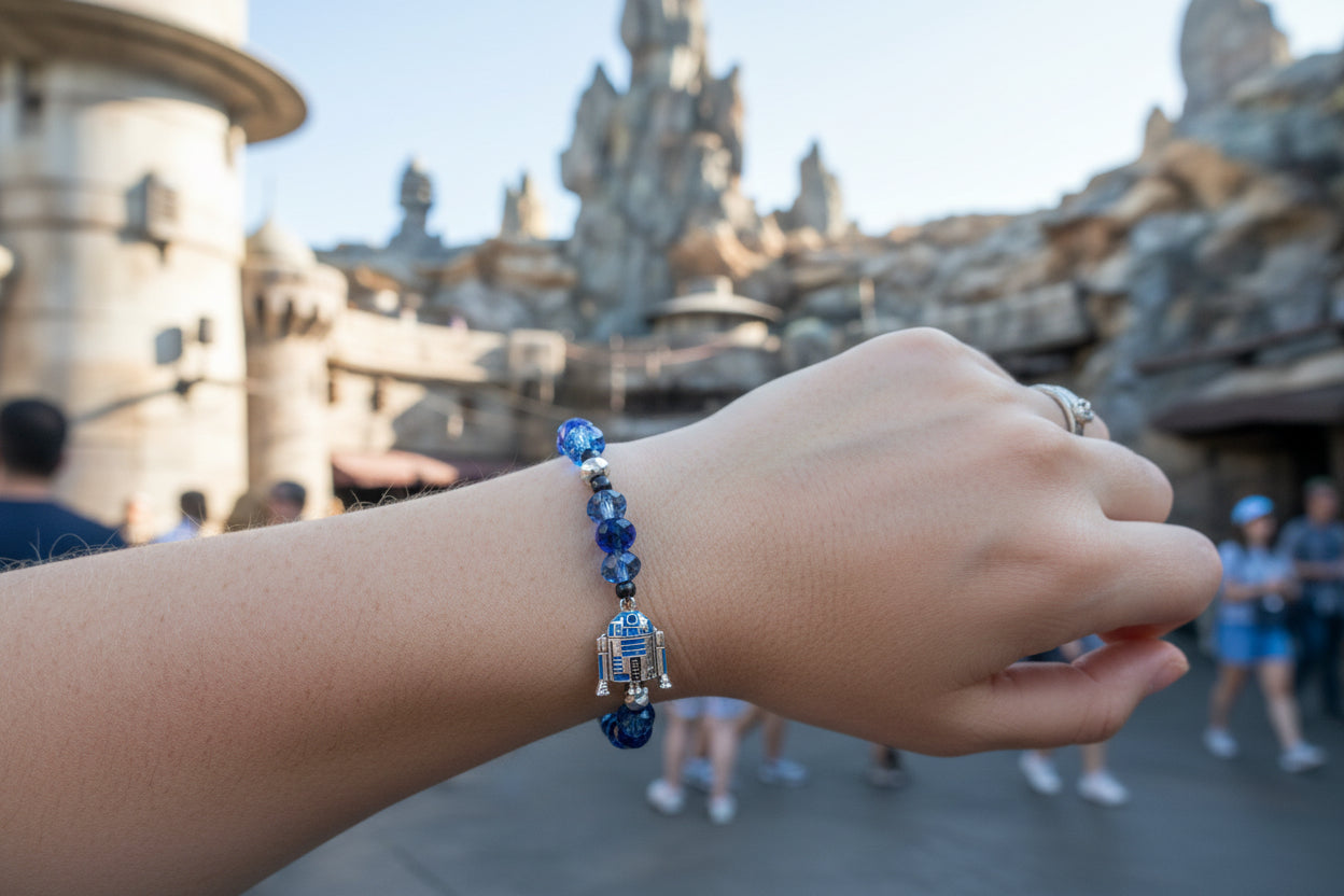 Bracelet with blue beads and a silver charm on a dark background