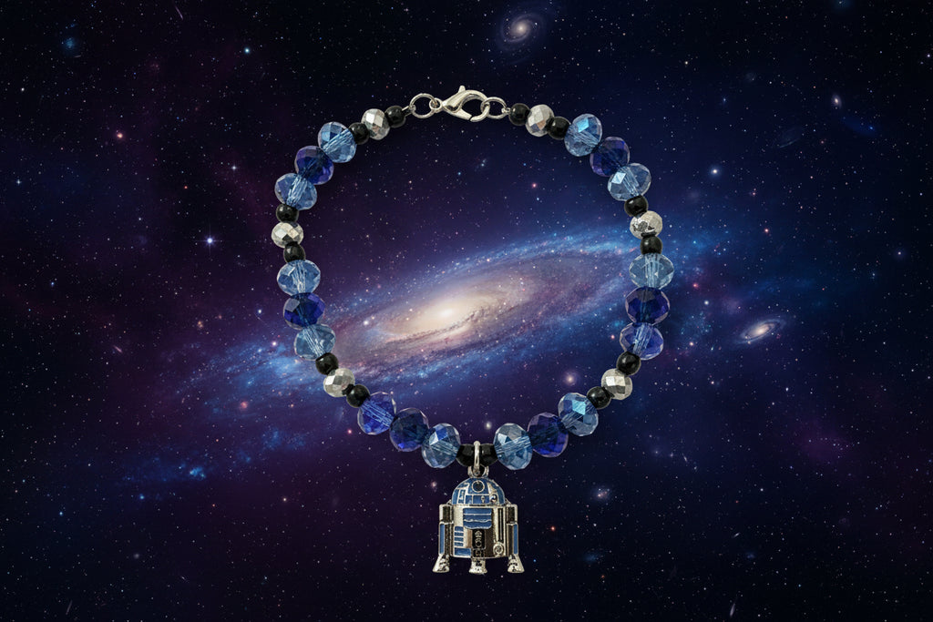 Bracelet with blue and silver beads and a R2D2 charm on a dark background