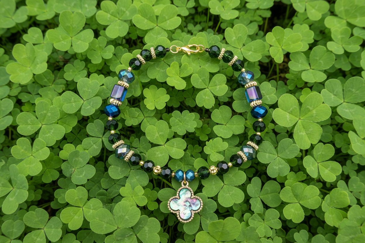 Beaded bracelet with a clover charm on a dark background