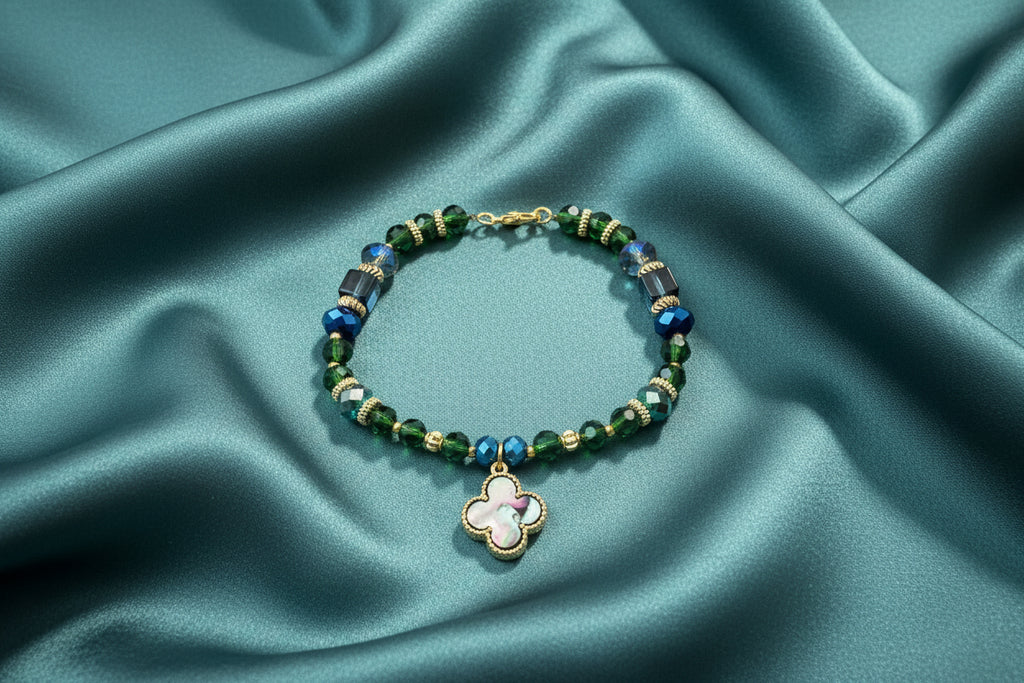 Beaded bracelet with a clover-shaped charm on a dark textured background