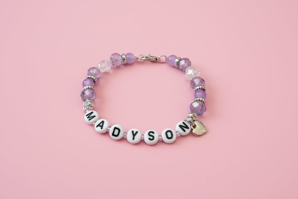 Beaded bracelet with 'MADYSON' on a dark background