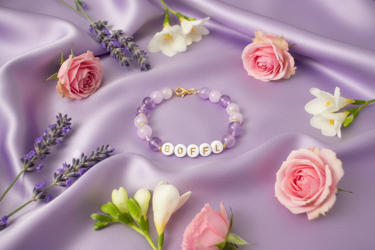 Bracelet with letter beads spelling 'BOFEL' on a dark background