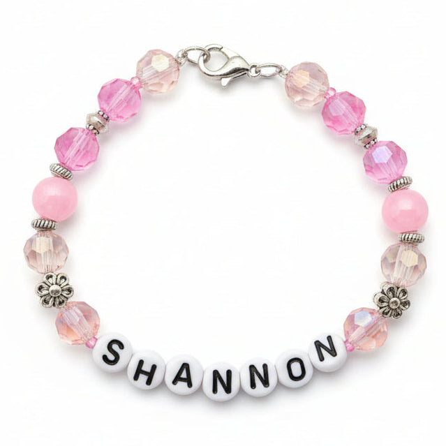 Beaded bracelet with 'SHANNON' charm on a black background