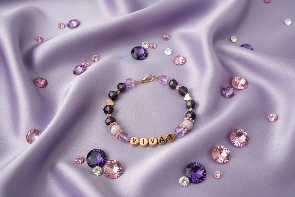Bracelet with beads and 'VIVAT' charm on a dark background