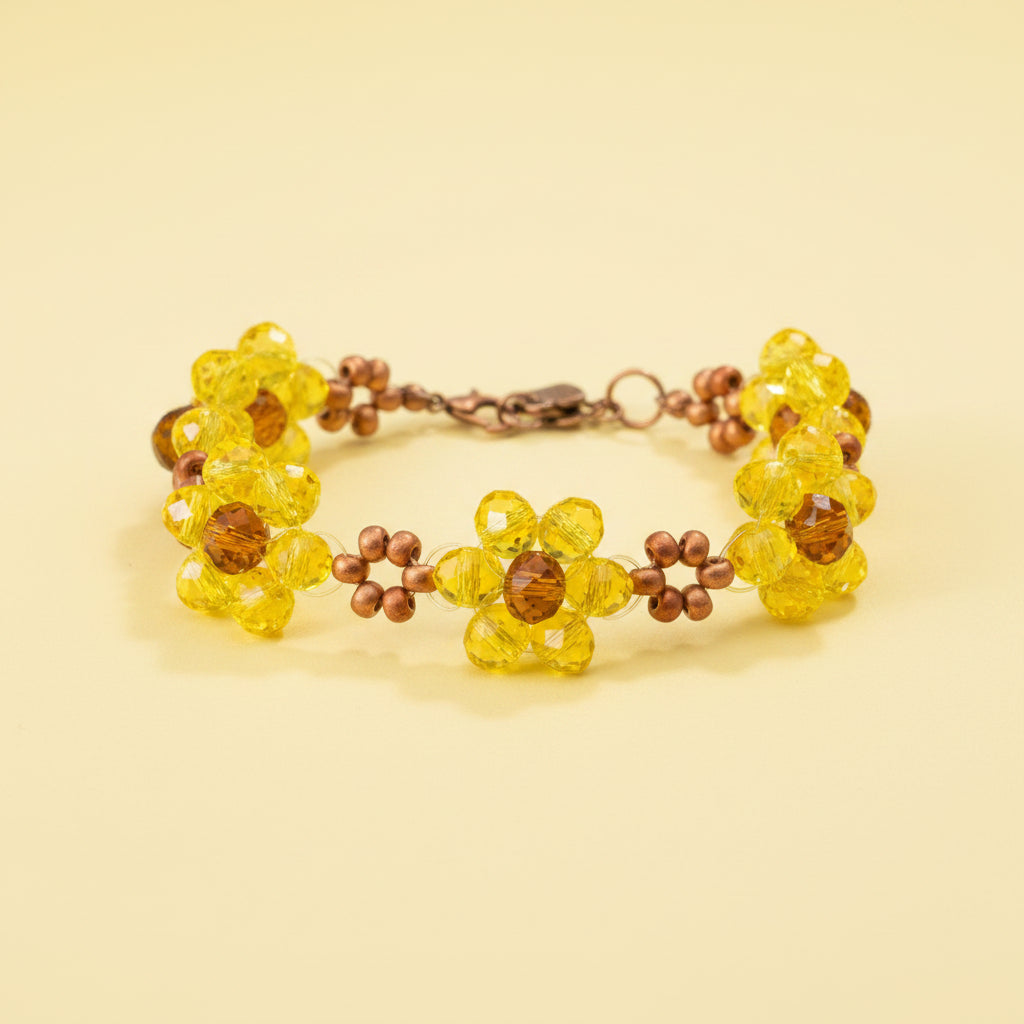A handmade beaded bracelet featuring three yellow faceted crystal flower clusters, accented with small brown beads and a rustic bronze-toned clasp, displayed on a dark textured background.