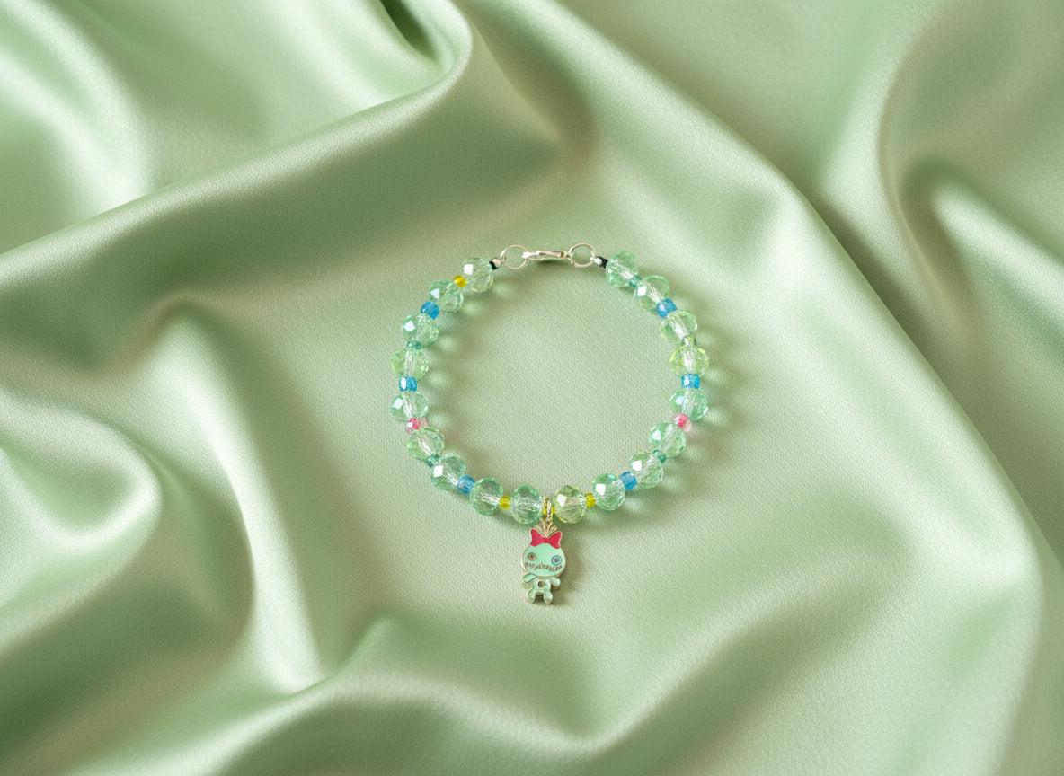 Beaded bracelet with a small charm on a dark textured surface