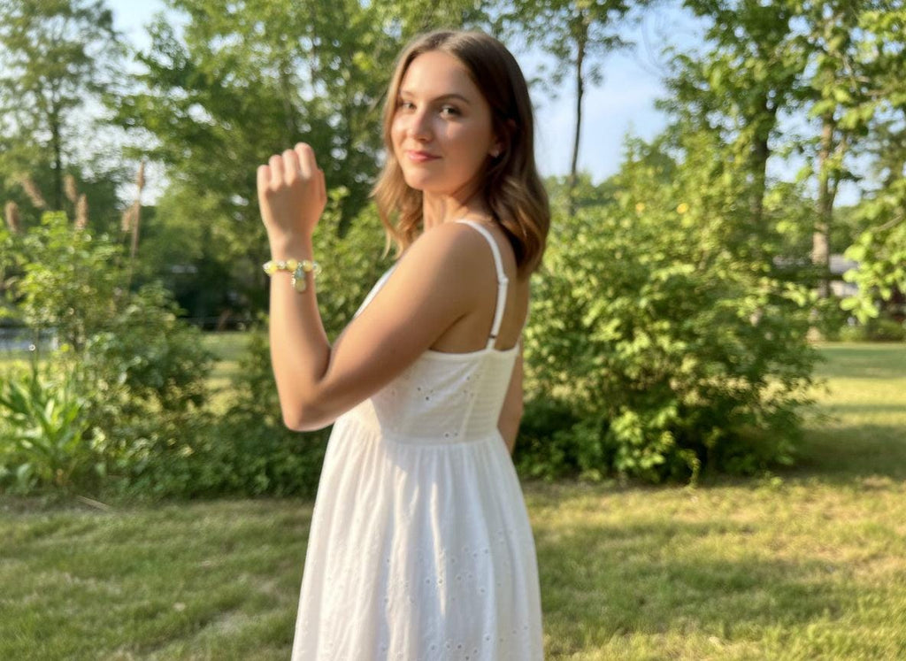 Bracelet with pineapple charm on a black surface