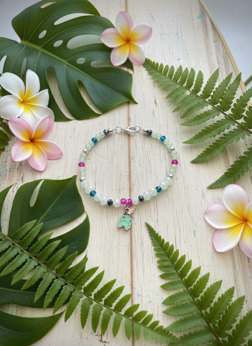 Beaded bracelet with a charm on a dark background