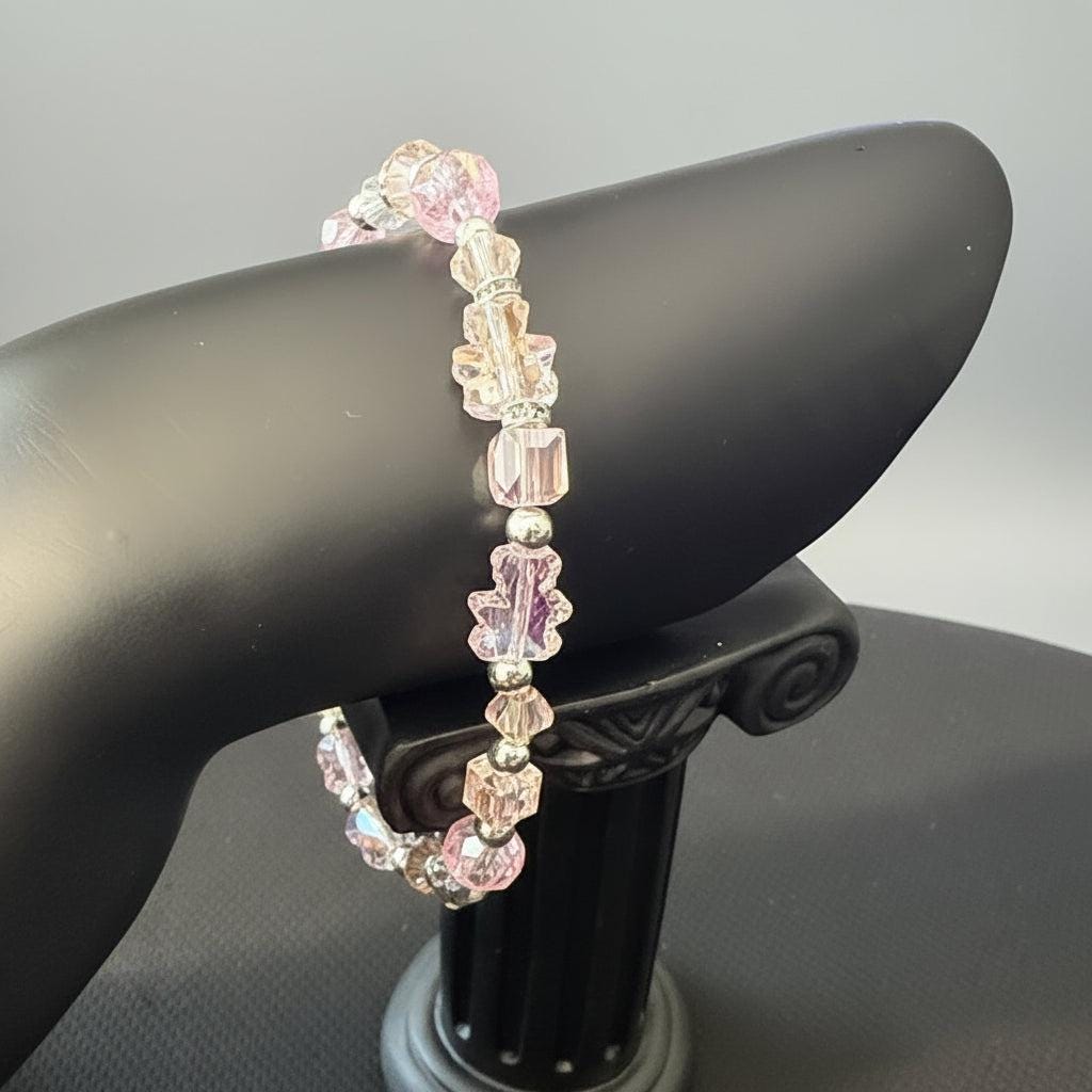Pink beaded hair tie on a car seat handle