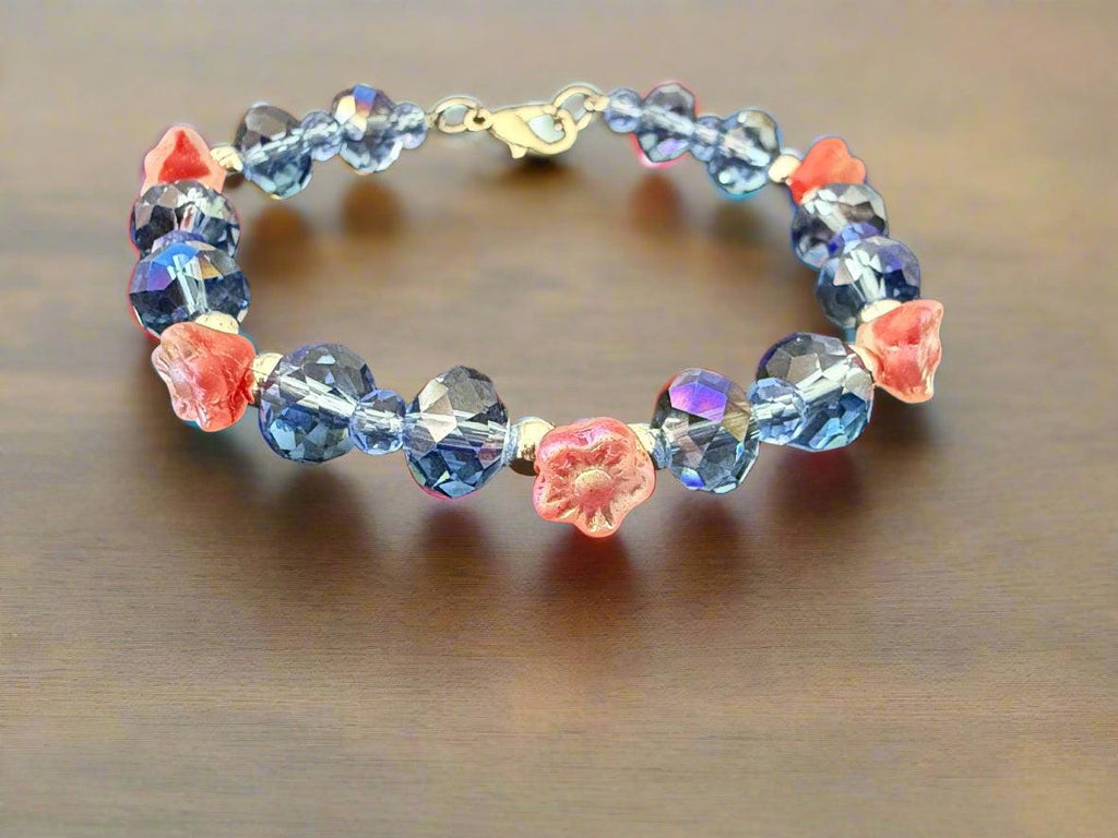 Beaded bracelet with blue and pink beads on a dark textured background