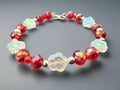 Bracelet with red and clear beads on a dark background