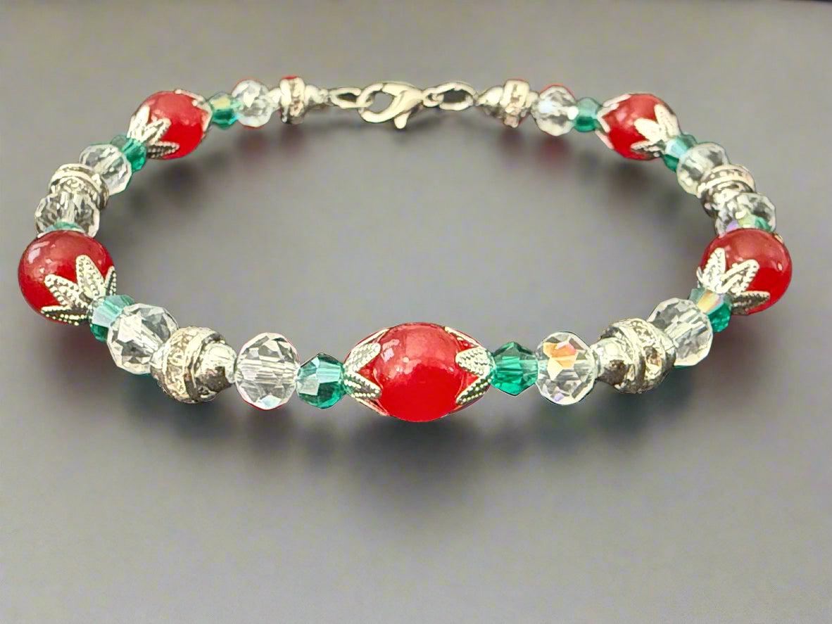 Beaded bracelet with red and clear beads on a dark background