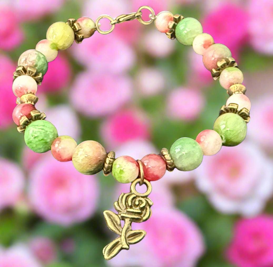 Beaded bracelet with a rose charm on a dark background