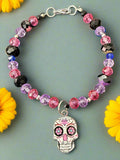 Bracelet with colorful beads and a skull charm on a dark textured background